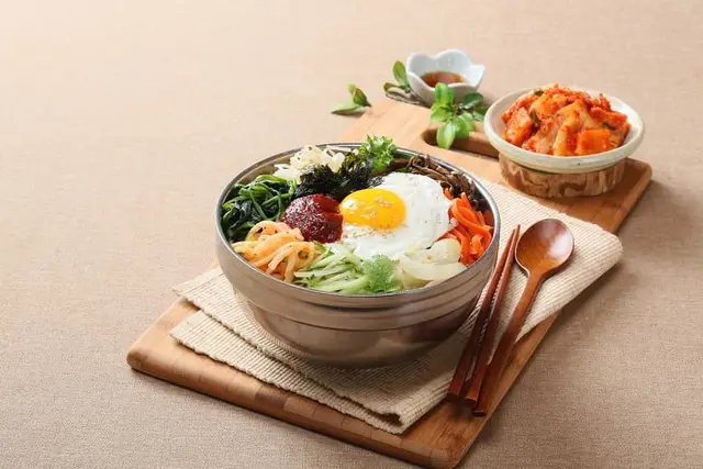 Korean Gochujang Tofu Bibimbap Bowl with Sesame Greens and Pickled Carrot