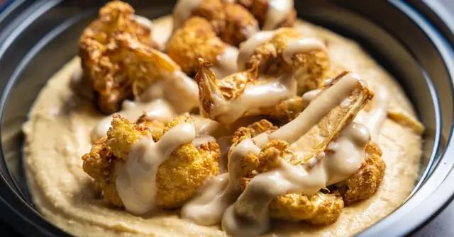 Spicy Harissa Roasted Cauliflower and Chickpea Bowl with Lemon-Tahini Dressing