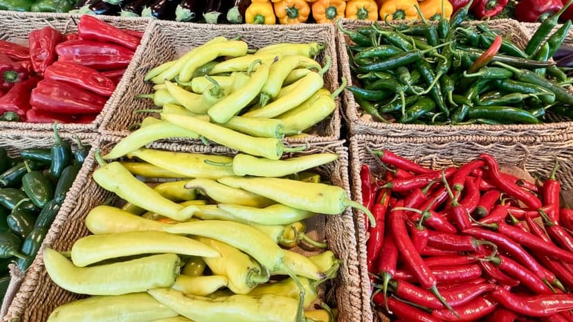 Vibrant array of peppers and vegetables in baskets at a market in Narre Warren, Australia.