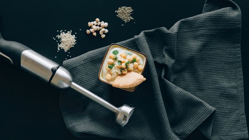 Delicious Mediterranean hummus with chickpeas and pita, styled in a modern flat lay.